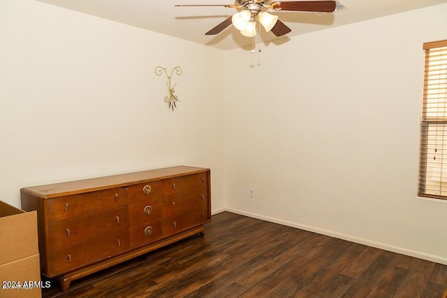 spare room featuring ceiling fan and dark hardwood / wood-style flooring