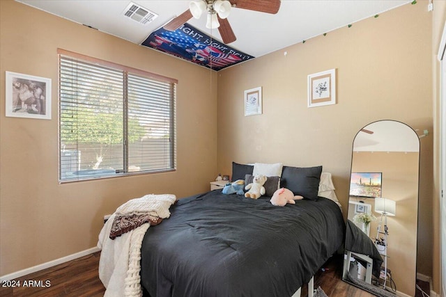 bedroom with dark wood-type flooring and ceiling fan