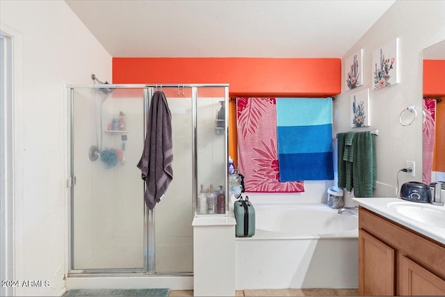 bathroom featuring vanity and shower with separate bathtub