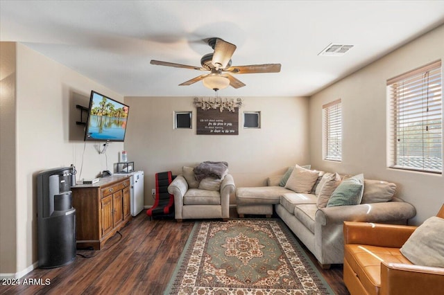 living room featuring ceiling fan and dark hardwood / wood-style flooring