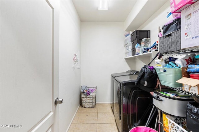 washroom with washer and dryer and light tile patterned floors