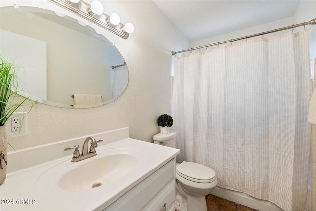 bathroom featuring toilet, a shower with curtain, and vanity