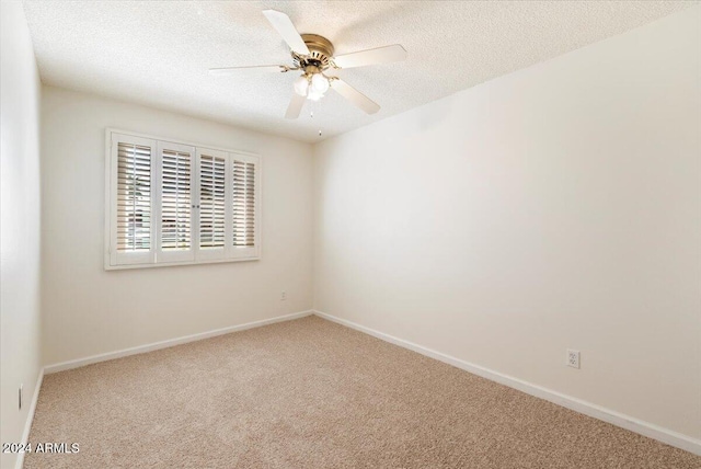 unfurnished room with carpet flooring, a textured ceiling, and ceiling fan