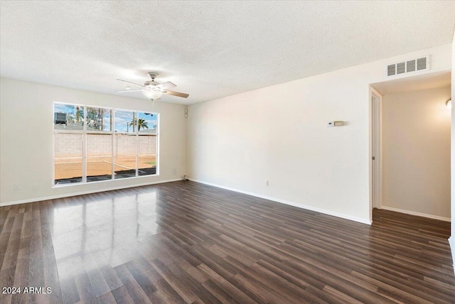 spare room with ceiling fan, a textured ceiling, and dark hardwood / wood-style floors