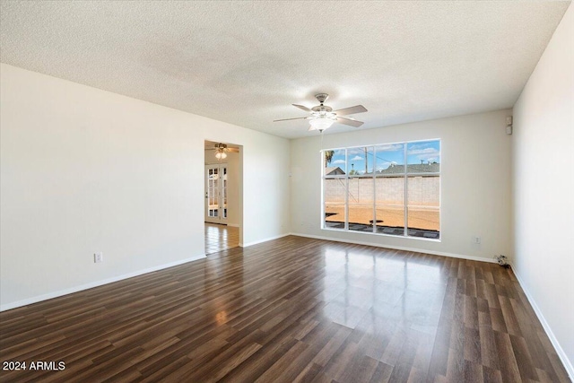 unfurnished room featuring ceiling fan, dark hardwood / wood-style floors, and a textured ceiling