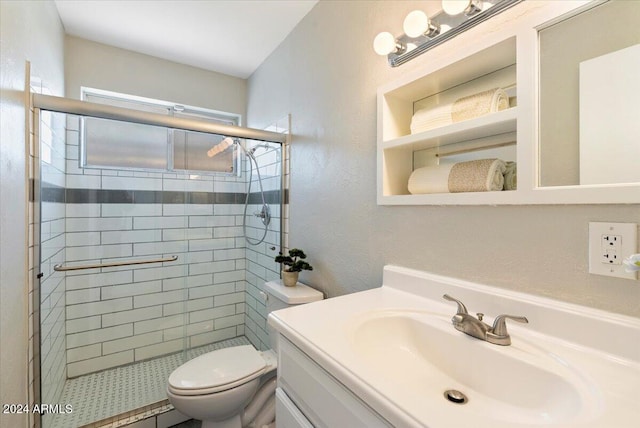 bathroom featuring vanity, toilet, and a shower with door