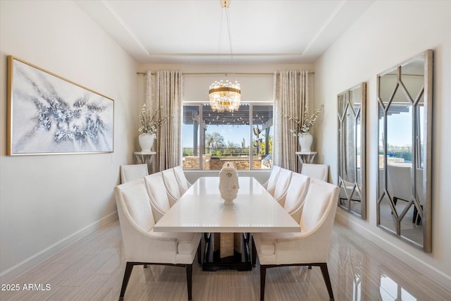 dining room with a notable chandelier and light wood-type flooring