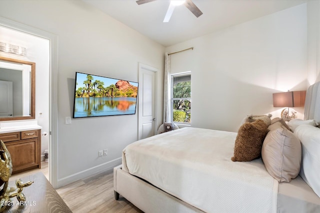 bedroom featuring ensuite bathroom, light hardwood / wood-style flooring, and ceiling fan