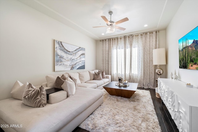 living room featuring dark hardwood / wood-style floors and ceiling fan