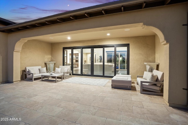 patio terrace at dusk featuring an outdoor hangout area