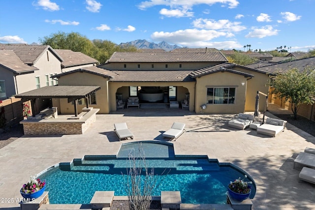 view of swimming pool with an outdoor hangout area, a patio area, and a hot tub