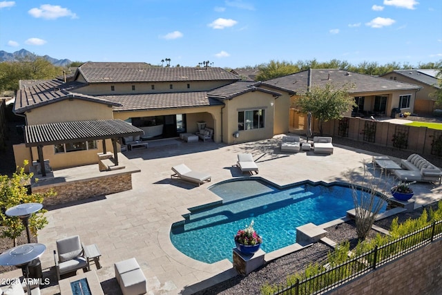 view of swimming pool featuring a gazebo, a patio area, a mountain view, and an outdoor living space