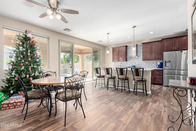 dining room with hardwood / wood-style floors and ceiling fan