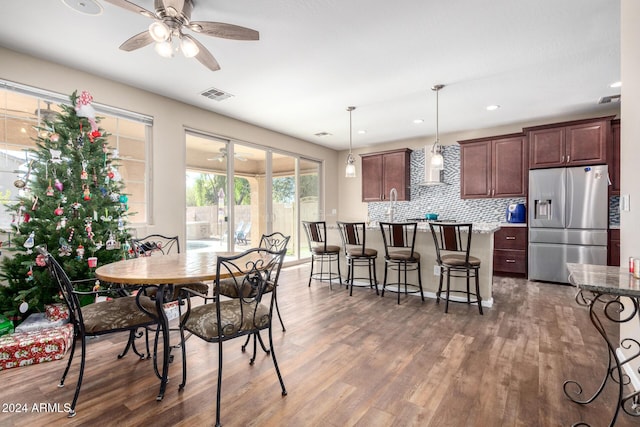 dining area with ceiling fan and dark hardwood / wood-style floors