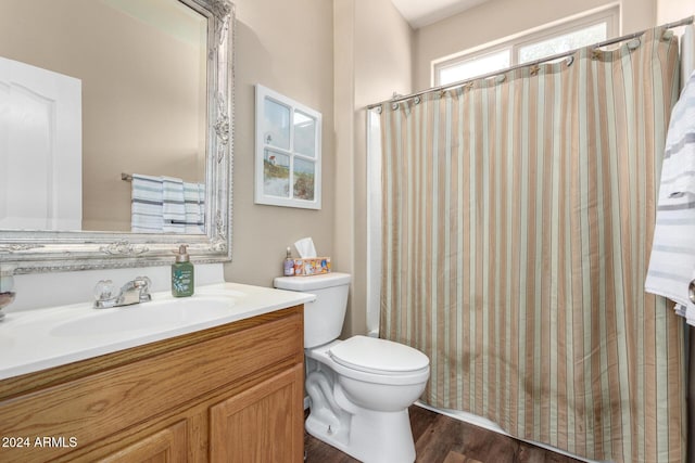 bathroom featuring walk in shower, toilet, vanity, and hardwood / wood-style flooring