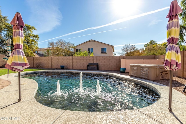 view of pool with a hot tub