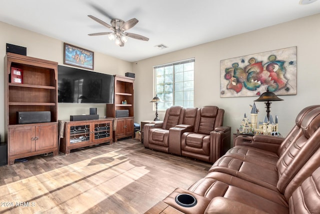 living room featuring hardwood / wood-style floors and ceiling fan