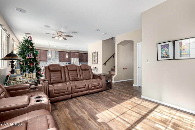 living room featuring hardwood / wood-style floors and ceiling fan