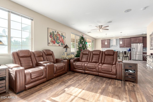 living room with wood-type flooring and ceiling fan