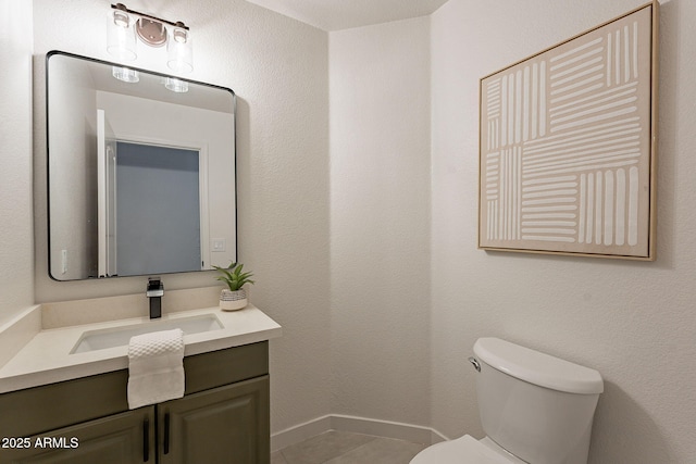 bathroom with vanity, toilet, and tile patterned flooring