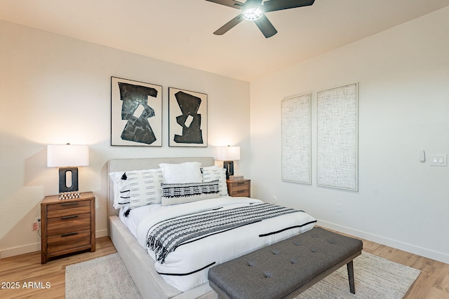 bedroom with ceiling fan and light hardwood / wood-style floors