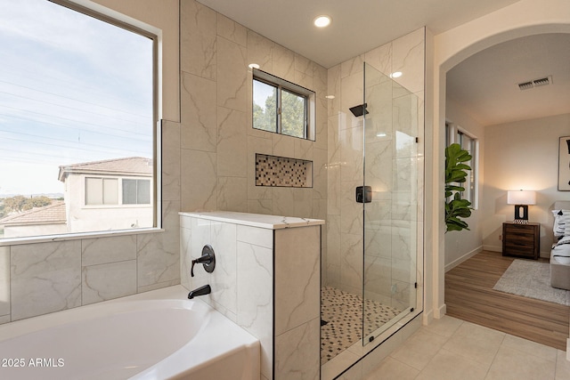 bathroom with tile patterned floors and plus walk in shower