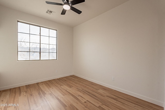 empty room with light hardwood / wood-style floors and ceiling fan