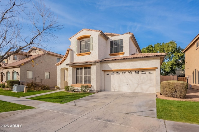 mediterranean / spanish-style home featuring a garage and a front lawn