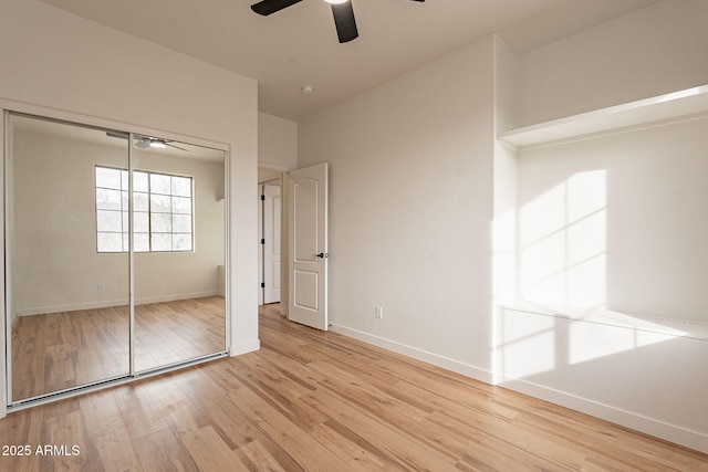 unfurnished bedroom with light hardwood / wood-style floors, ceiling fan, and a closet