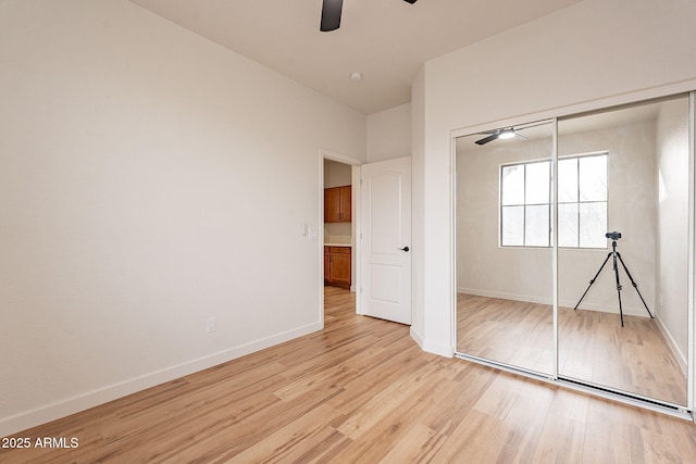 unfurnished bedroom with light hardwood / wood-style flooring, a closet, and ceiling fan