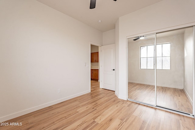 unfurnished bedroom featuring ceiling fan, light hardwood / wood-style floors, and a closet