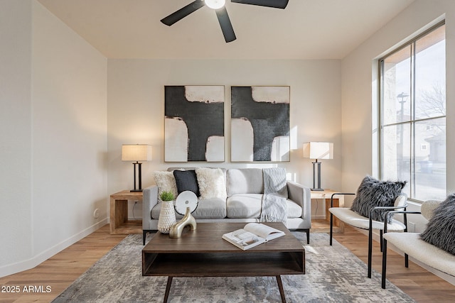 living room with wood-type flooring and ceiling fan