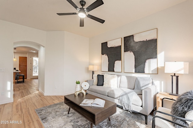 living room with wood-type flooring and ceiling fan