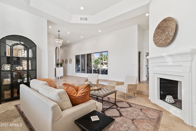 living room featuring a towering ceiling and a raised ceiling