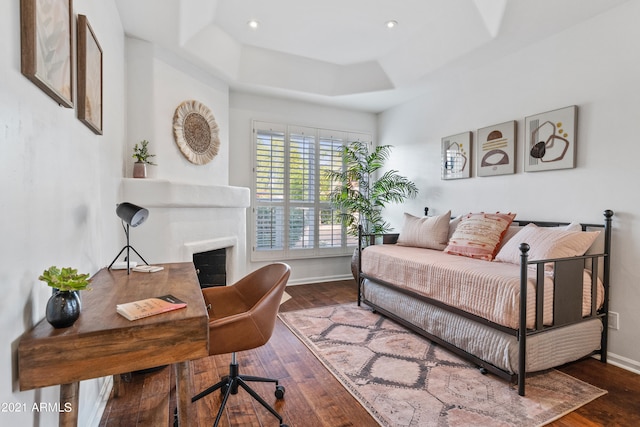 bedroom featuring hardwood / wood-style flooring and a raised ceiling