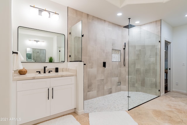 bathroom featuring vanity, a shower with door, and tile patterned floors