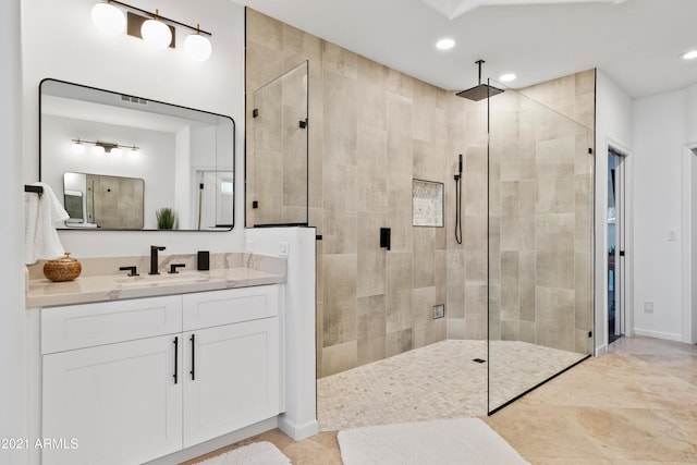 bathroom featuring tile patterned floors, vanity, and walk in shower