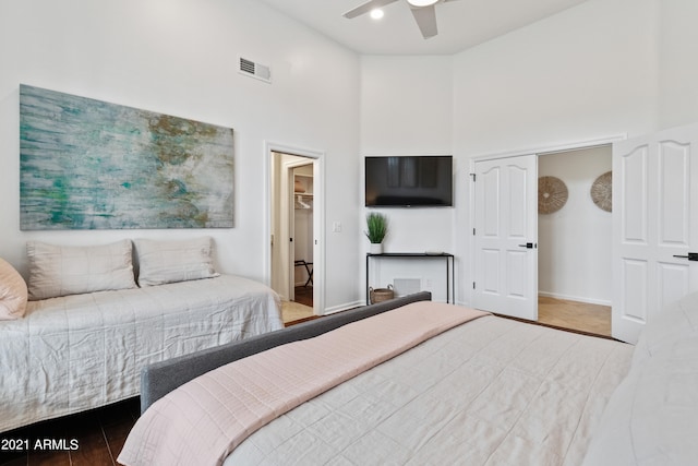 bedroom featuring a closet, high vaulted ceiling, hardwood / wood-style floors, and ceiling fan