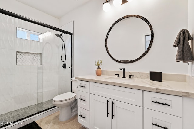 bathroom with tile patterned flooring, a shower with shower door, vanity, and toilet