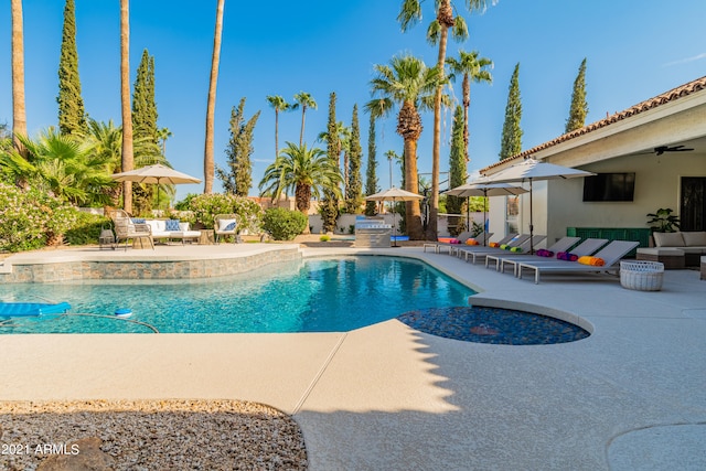 view of pool with a patio and an outdoor living space