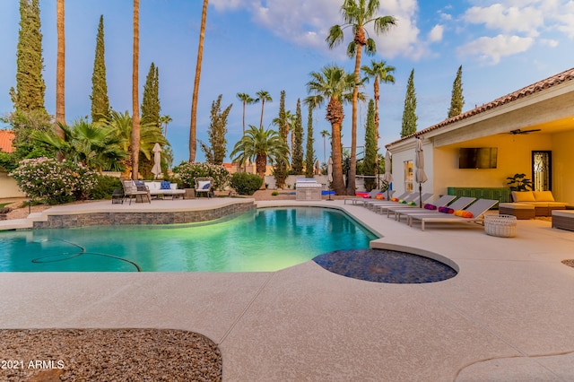 view of pool featuring outdoor lounge area, ceiling fan, and a patio area