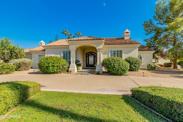 mediterranean / spanish-style home featuring a front lawn