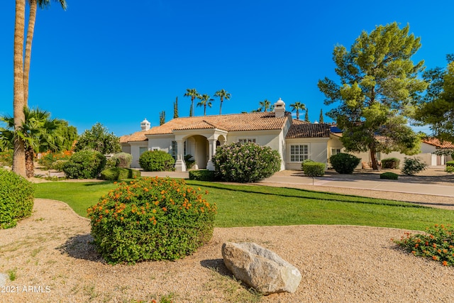 mediterranean / spanish-style home with a front yard