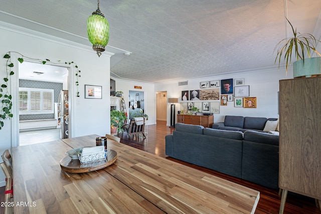 living room with ornamental molding, a fireplace, and hardwood / wood-style floors