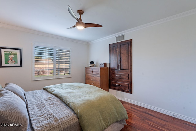 bedroom featuring ceiling fan, ornamental molding, and dark hardwood / wood-style floors