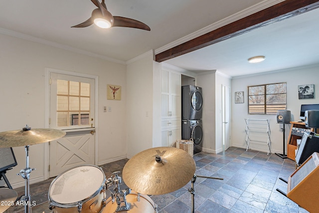 dining room featuring crown molding, ceiling fan, and stacked washer and clothes dryer