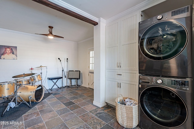 laundry area with ceiling fan, ornamental molding, and stacked washer / drying machine