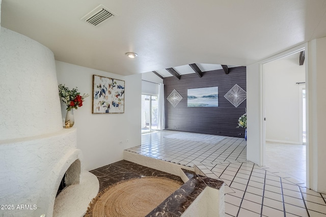 corridor featuring vaulted ceiling with beams and tile patterned floors