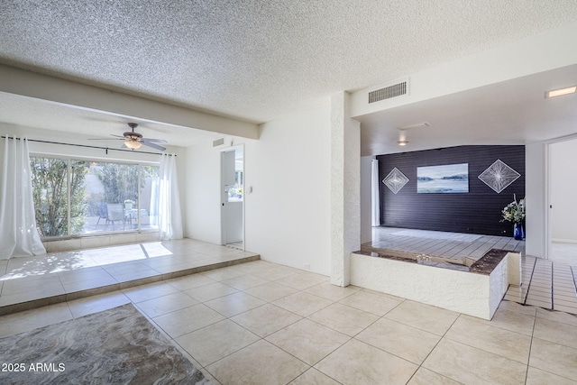 entryway featuring a textured ceiling and light tile patterned floors