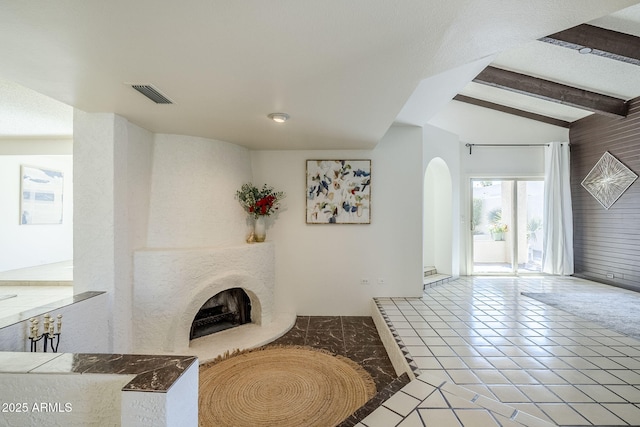 living room featuring lofted ceiling with beams and tile patterned flooring